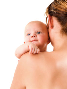 Pregnant woman holding a baby.